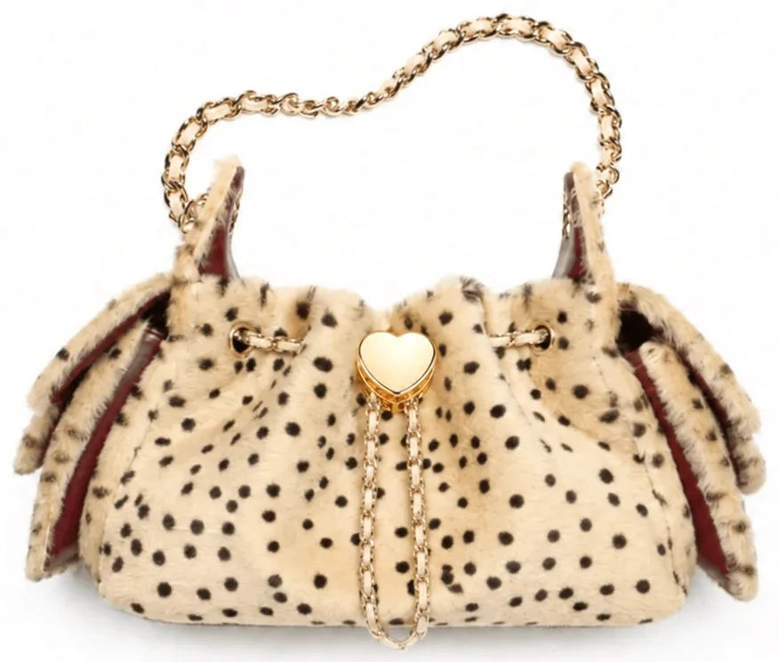 The Leopard Heart: cream faux fur bucket bag with black spots and a gold-tone chain